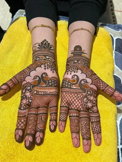 This design was created for a devotee of Lord Shiva, featuring a Shivling symbol on one wrist and the words 'MAMMAS LOVES' on the palm.