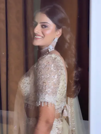 A beautiful candid shot of Kritika. Her makeup is fresh and glowing, proving that a simple and elegant approach can be incredibly impactful for pre-wedding events.
