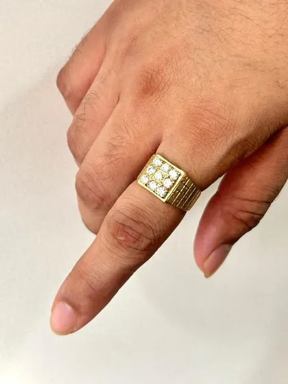 A different perspective of the square-faced diamond ring, this view highlights the texture on the band and the brilliance of the nine diamonds as they catch the light. It shows the ring's commanding presence on the hand.