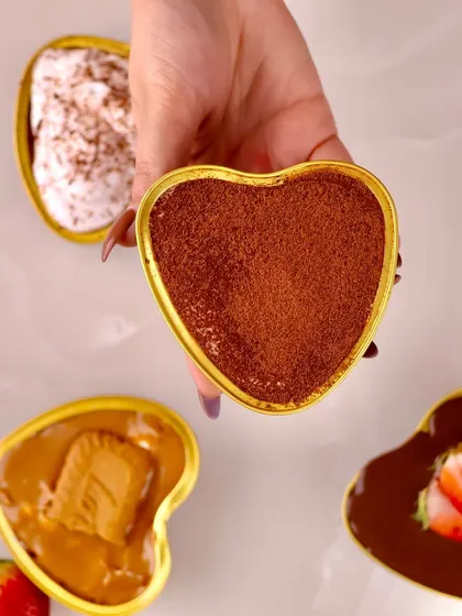 A close up of our classic Tiramisu, with its rich cocoa dusting, served in a heart shaped dish for Valentine's Day.