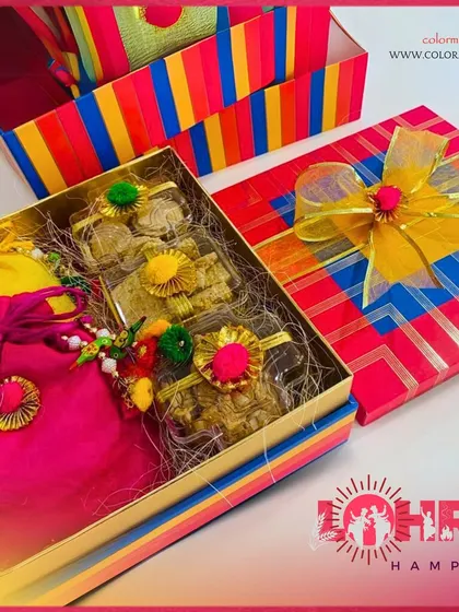 Our Lohri hampers are designed to spread warmth and joy. This colorful box is filled with traditional Lohri sweets and snacks, along with a bright pink potli bag.