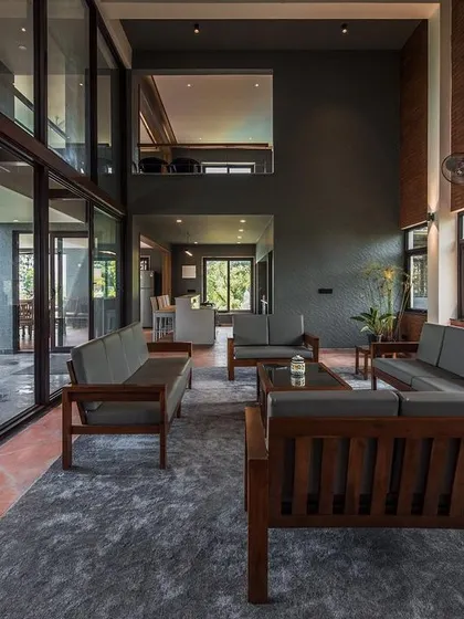 An interior view looking out from the living area, demonstrating the open-plan design and the seamless transition to the outdoor patio and lawn.