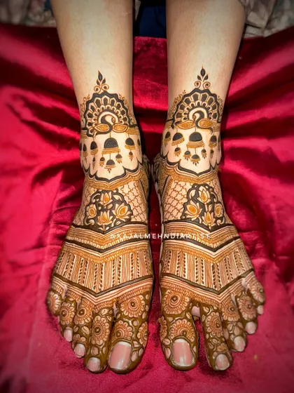 A rich, dark stain on this intricate foot design. The pattern includes hanging bells and lotus flowers, creating a beautiful bridal look.