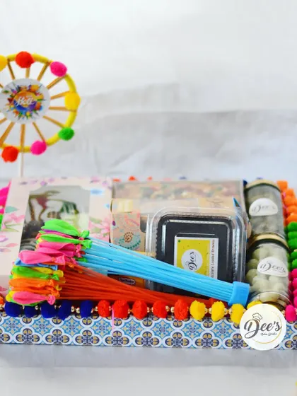 A festive tray filled with Holi goodies. This hamper includes my special Chocolate Gujiyas, Thandai Tea Cake, and colorful gulal for the celebration.