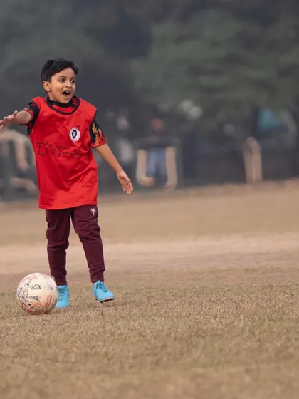 The pure happiness of playing football. This player's expression captures the joy of the game.