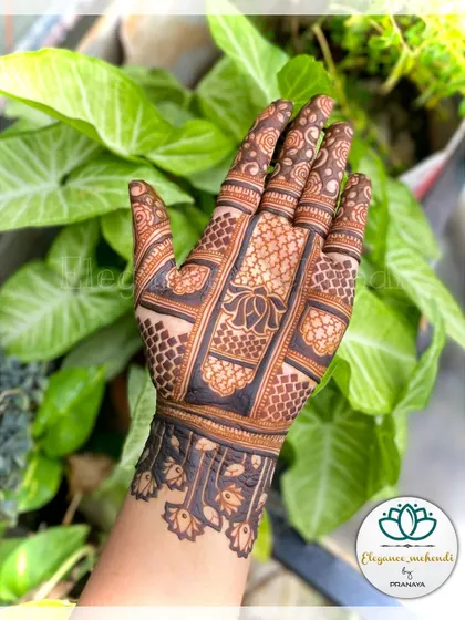 An elegant backhand design featuring a central lotus motif, created for a festive occasion.