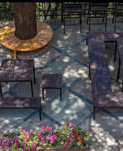 An overhead view of the flexible seating arrangements at the Woodstock School hub. The modular furniture can be reconfigured for different events and group sizes, demonstrating our focus on creating adaptable urban spaces.
