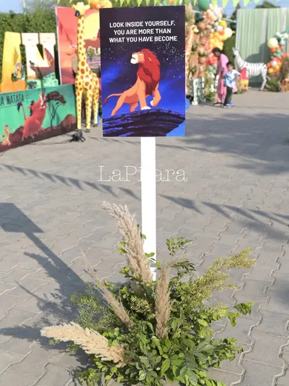 Inspirational quote signs from The Lion King placed throughout the event space add a thoughtful and thematic touch.