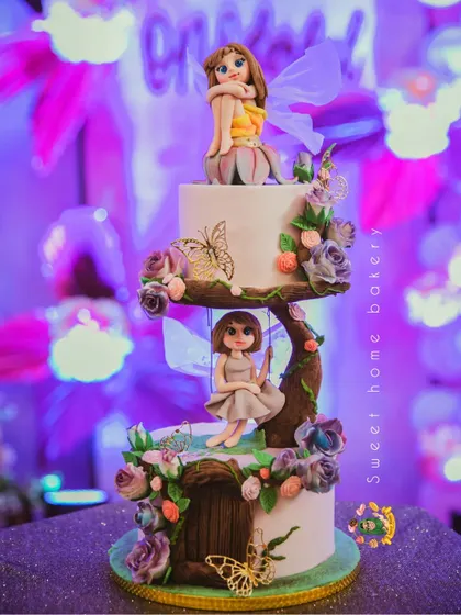 Another view of the magical fairy cake, showing the intricate details of the tree branch and flowers.