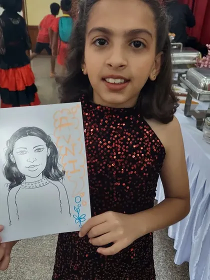 Another happy guest with her finished caricature drawing. Our artists are great with kids and create wonderful portraits that always bring a smile.