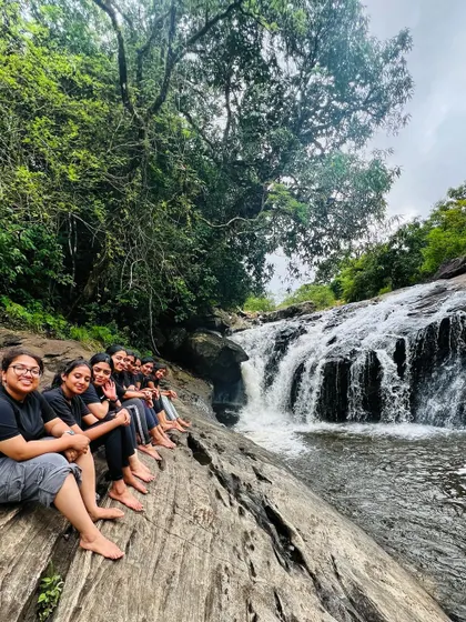 A group of friends sitting by a stream, enjoying a quiet moment.