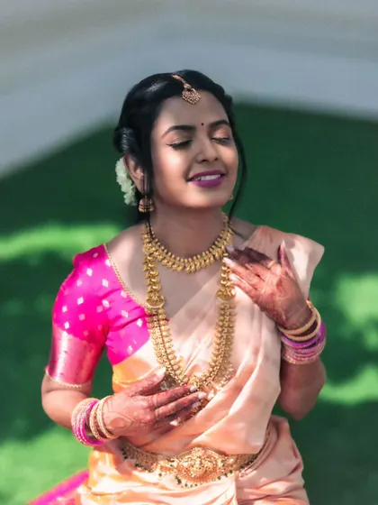 A sun-drenched portrait of a bride with her eyes closed, savoring the moment. The warm light and her joyful expression perfectly capture the happiness of her wedding day.