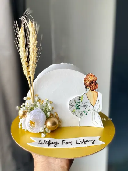 A chic cake-top-forward design for a bride-to-be. This 500g Chocolate Truffle cake features a beautiful illustration and elegant dried floral accents.