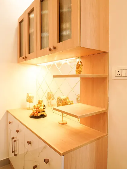A close-up of the custom crockery unit, showing the light wood finish, fluted glass doors, and elegant display shelves.