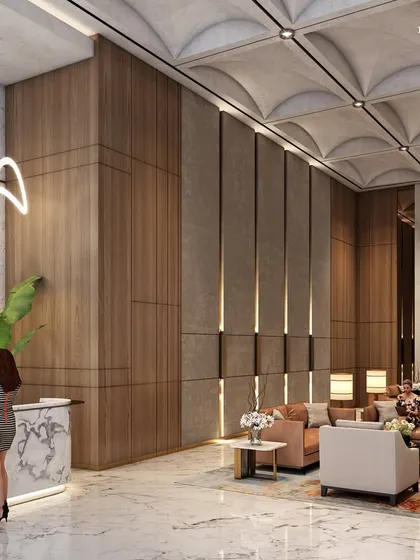 The reception lobby of a luxury South Mumbai residence, where a vaulted ceiling and wood-paneled walls create a warm and elegant welcome. A sculptural light fixture and curated art add to the atmosphere of refined sophistication.