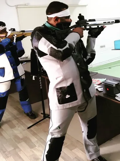 Shooters engaged in a serious training session, focusing on their stance and aim. Repetition and discipline are key to mastering the sport.