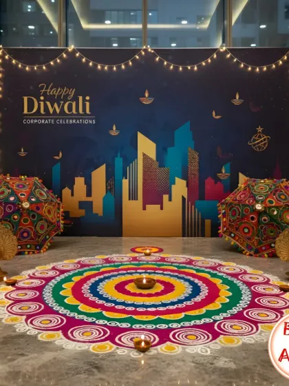This corporate Diwali photo corner combines modern and traditional elements. A custom backdrop featuring a city skyline is paired with a vibrant, handcrafted rangoli and ornate Rajasthani umbrellas, creating a unique and beautiful spot for employees to capture festive memories.