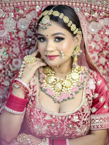 This student's work highlights a modern bridal look with a focus on radiant skin and elegant jewelry. We teach how to create a sophisticated and polished finish.