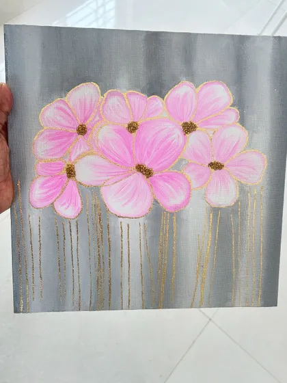 A simple yet elegant floral painting on a grey canvas with gold drip effects.