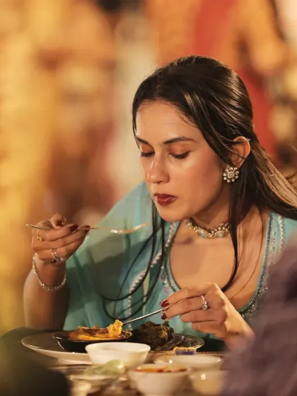 A guest is fully immersed in the flavours of her meal. These candid moments of indulgence highlight the true essence of a successful celebration.