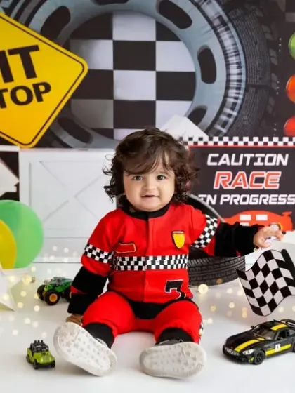 Another little racer ready to hit the track. The full setup with Lightning McQueen and checkered flags makes for an exciting first birthday theme.
