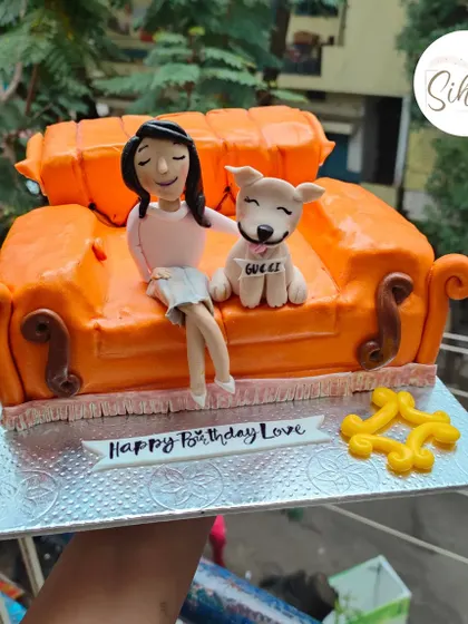 I'll be there for you. A detailed, fully sculpted cake of the iconic orange couch from "Friends," complete with a custom figurine and her adorable dog.