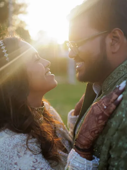 This is what it's all about. A close-up shot during golden hour, capturing a genuine smile and the warmth between a couple. We focus on these unposed, intimate moments that truly reflect your connection.