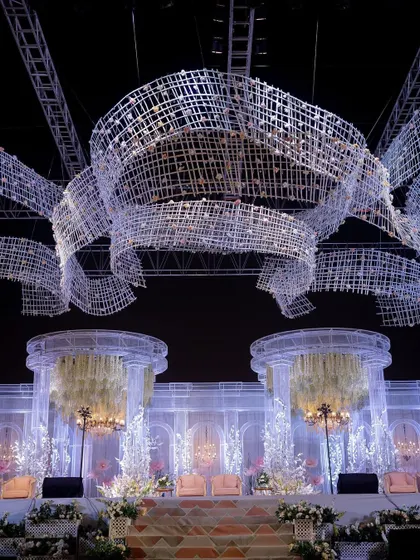 A view from below the custom-fabricated overhead installation. These massive, woven structures were designed to look like flowing ribbons of crystal, adding a sense of movement and grandeur to the night sky.