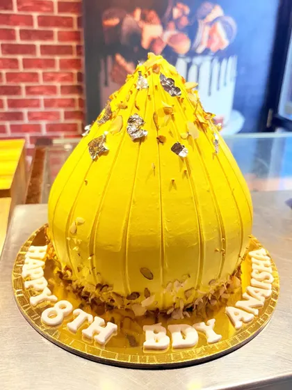 A unique cake shaped like a traditional Modak for an 18th birthday, combining tradition with modern celebration.
