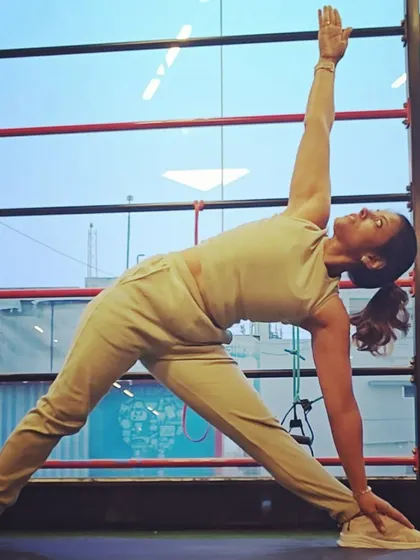 Moving into Triangle Pose, or Trikonasana. This classic standing pose is excellent for stretching the side body, opening the hips, and strengthening the legs and core.