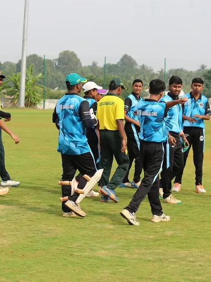 Players congratulate each other after taking a wicket in the Dasara Cup.