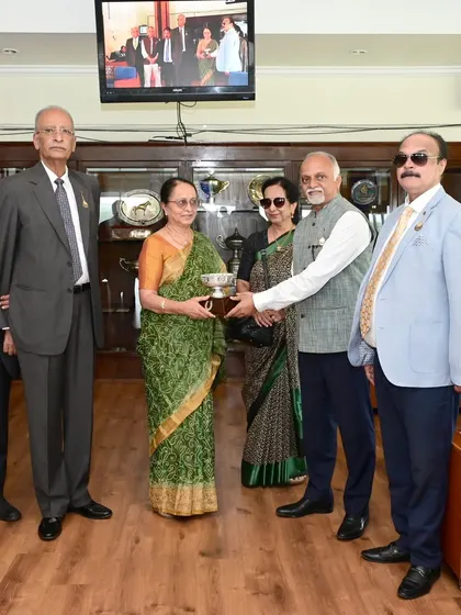 Mrs. Vijaya S Gowda presents The Dr. K.M. Srinivasa Gowda Memorial Cup to the owners of Scent of Rain in a private ceremony.