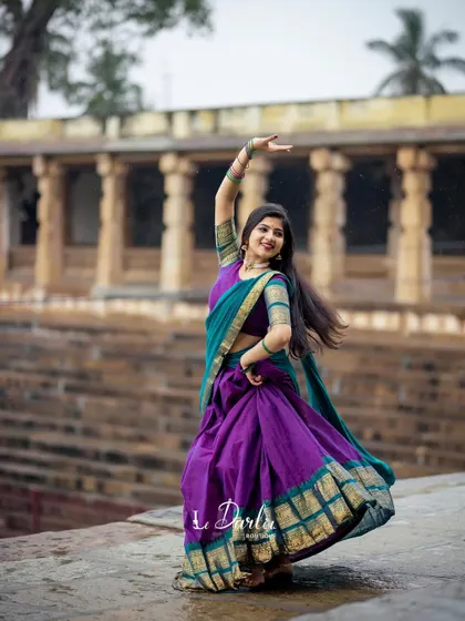 A series of photos from a collaboration with a designer, showcasing a beautiful half-saree against the backdrop of ancient temple pillars. I love how the vibrant colors of the costume stand out.
