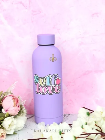 A close-up of the "Self Love" personalized water bottle in a beautiful pastel purple. It's a great reminder to stay hydrated and practice self-care every day.