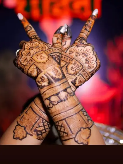 A creative pose highlighting the intricate details on the back of the hands, including personalized blocks and elephant motifs.