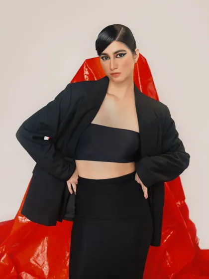 A powerful, classic fashion pose. The oversized blazer and minimalist styling create a timeless and confident look.