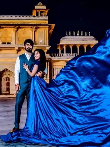 Another epic shot showcasing the full trail of the electric blue gown against a heritage building at night. This is how you make a statement.
