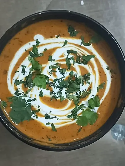 A bowl of my rich and creamy Kadai Paneer, garnished with fresh cream and coriander. It's a perfect dish for any special meal.