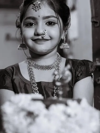 A close-up portrait of our little muse, Saanvi, in her traditional attire, complete with classic jewelry.