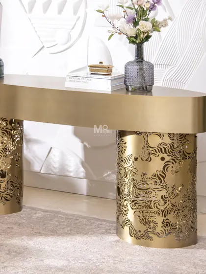 This is where metal meets art. The Ferrosa Console is sculpted from high-grade metal with a brushed antique gold finish. The base features intricate laser-cut carvings inspired by traditional Jaali work, reimagined in a contemporary form. It’s a piece that balances opulence with modern restraint, perfect for an elegant entryway.