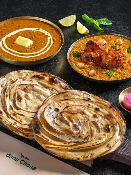 A non-vegetarian combo of Dal Makhani, Chicken Tikka Masala, and Lachha Parathas.