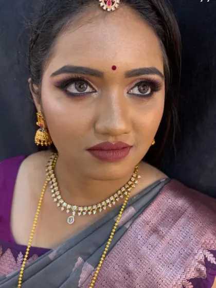 A stunning reception look with smoky purple eyeshadow and a matte mauve lip, perfect for an evening event.