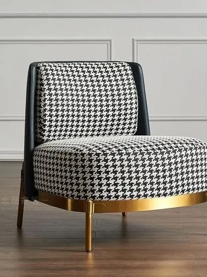 We selected this classic houndstooth pattern armchair for a client's living room. The bold fabric combined with the brass-finished base adds a touch of timeless elegance.