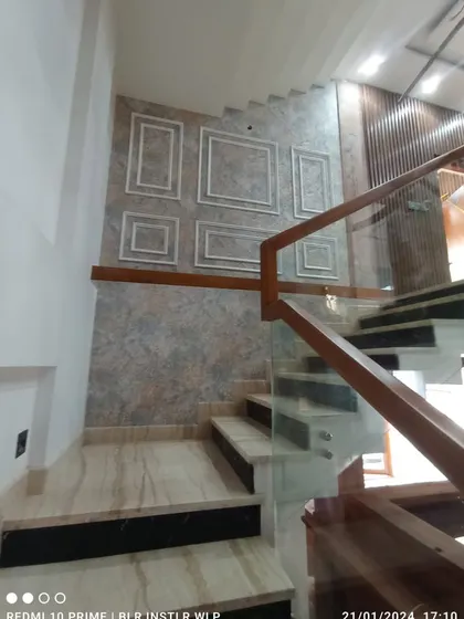 Another view of the paneled staircase wall.