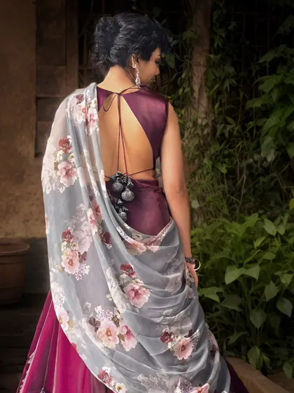 The back of this wine-colored lehenga features a deep, open-back design with delicate tassels, adding a touch of glamour and sophistication.