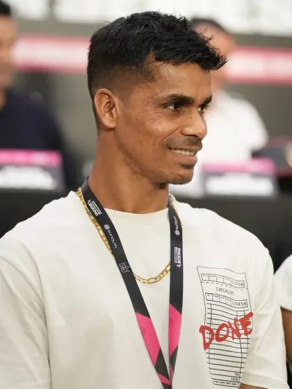 A slight smile, but the eyes show the competitive fire within.