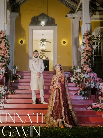 A grand and regal portrait of the couple on the steps of the Silva Heritage villa in Goa, perfectly capturing the essence of a destination wedding.