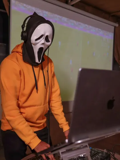 Another shot of our DJ in a Scream mask, setting the spooky tone for the night.