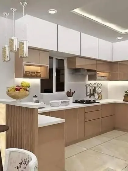 This kitchen features a breakfast counter with a fluted panel base. The two-tone design combines beige and white cabinets with elegant pendant lighting for a modern, inviting look.