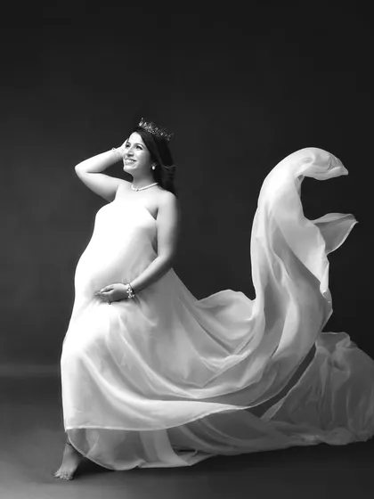 A regal pose in black and white, with a flowing gown and a crown. I love empowering mothers-to-be to feel like the queens they are.